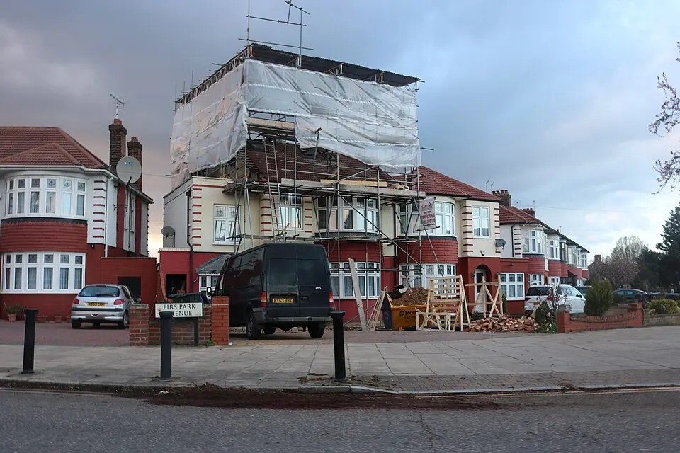 An English house during roof replacement with temporary weather protection