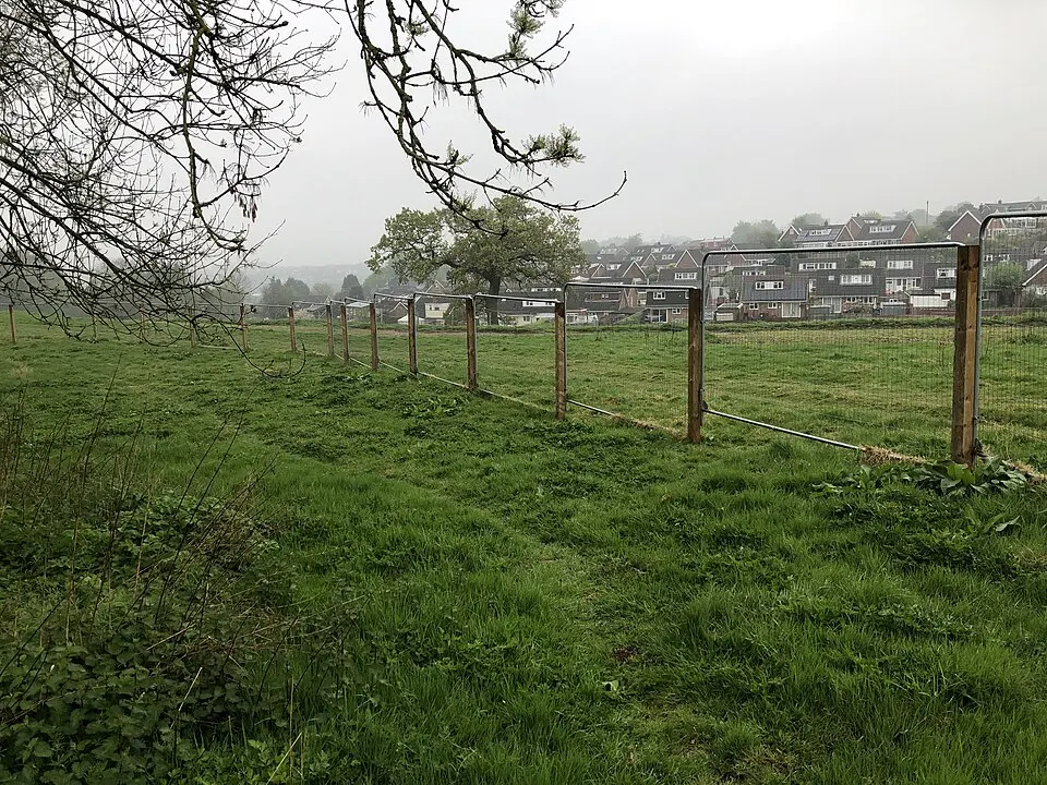 Heras fencing around land beside English homes