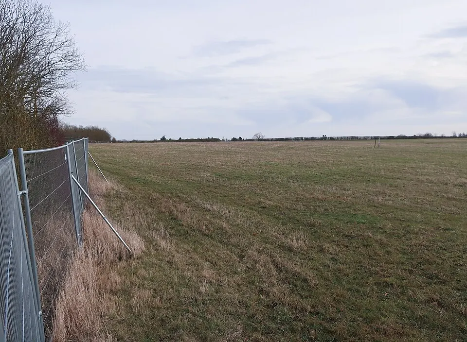 Temporary metal mesh fencing along a site boundary in England